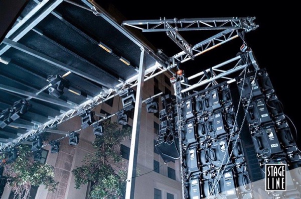 Line array speakers flown from the SL100 roof structure at night